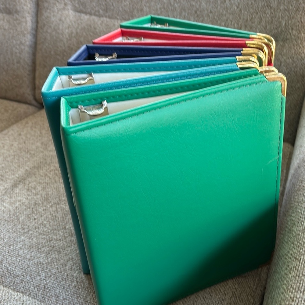 5 colorful like new binders. 2 1/2”x 8”x 9”. Great for crafting, recipes, photos